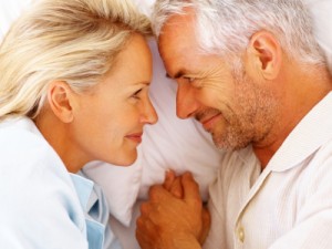 Older couple smiling in bed