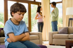 Distraught child listening to parents argue