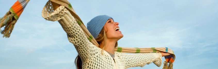 woman with her hands out to her sides being happy