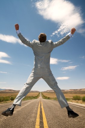 Man jumping above road