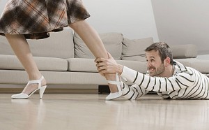 Man holding on to woman's leg