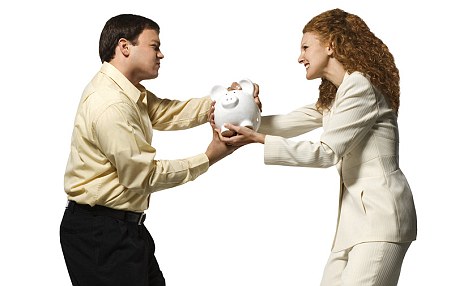 Man and woman fighting over piggy bank