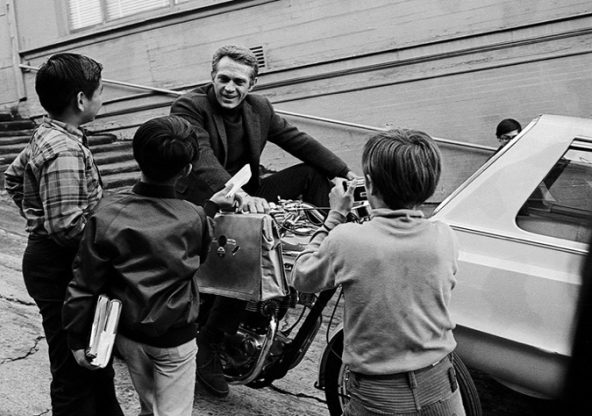 Motorcycle man talking with kids