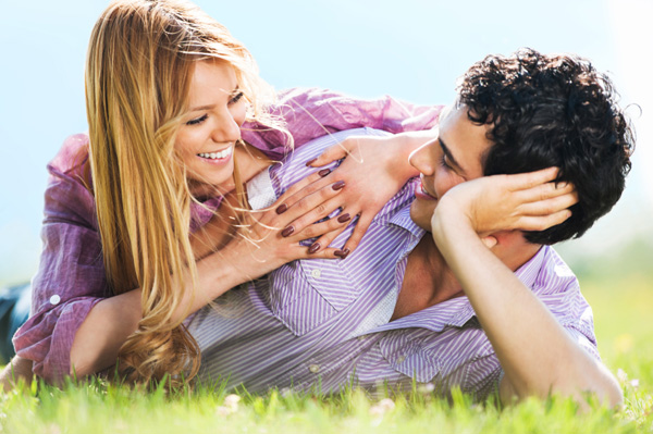 Couple lying on grass and talking it out