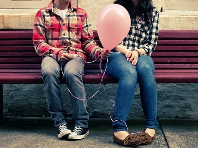 Man giving a balloon to a woman