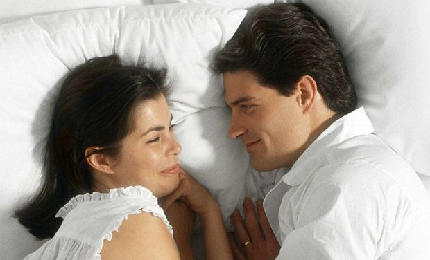 Couple having a good chat in bed