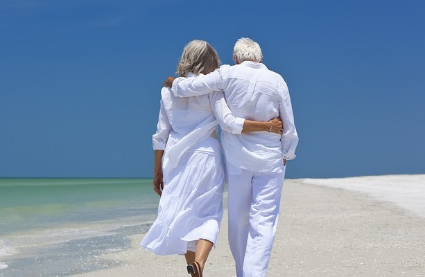 Older couple walking along beach