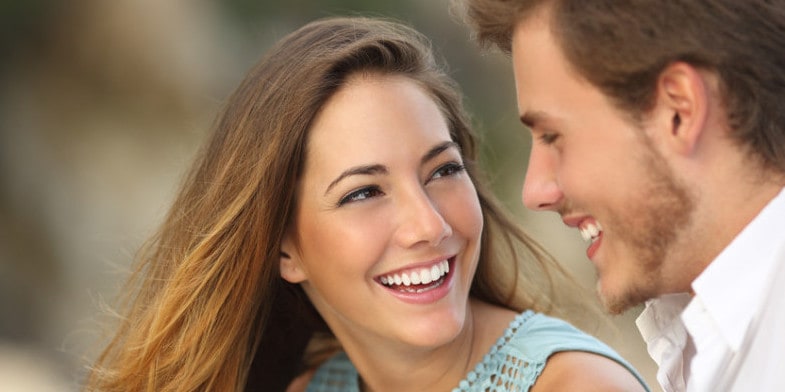 couple laughing and talking face to face