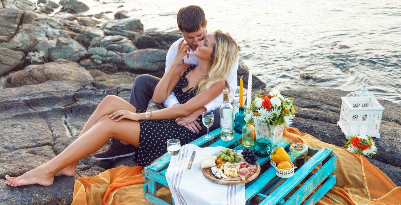 young couple having a picnic on the beach 