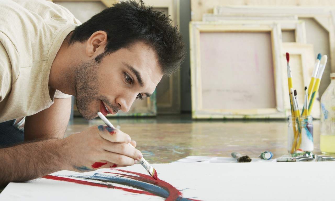 man painting a canvas