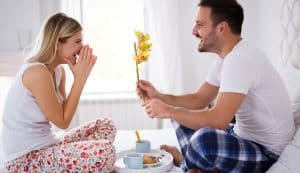 man giving wife flower