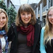 three happy women posing on the street