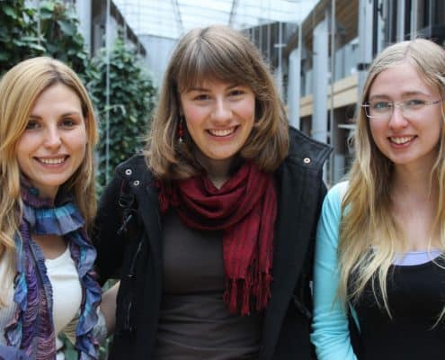three happy women posing on the street