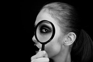 woman-looking-thru-magnifying-glass