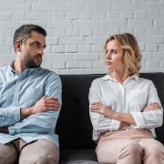 man and woman looking at each other upset