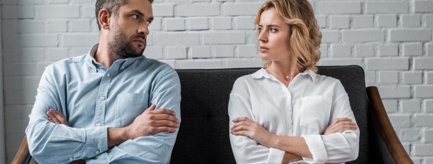 man and woman looking at each other upset