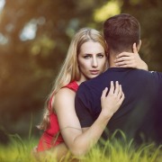 woman-holding-man-in-forest