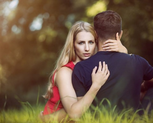 woman-holding-man-in-forest