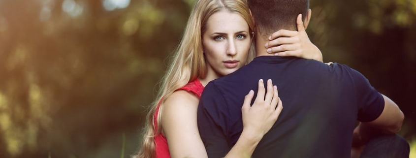 woman-holding-man-in-forest